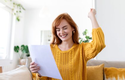 Excited young woman hold paper letter feel euphoric receiving job promotion or tax refund from bank, happy woman reading paperwork document smiling of good pleasant news, getting student scholarship