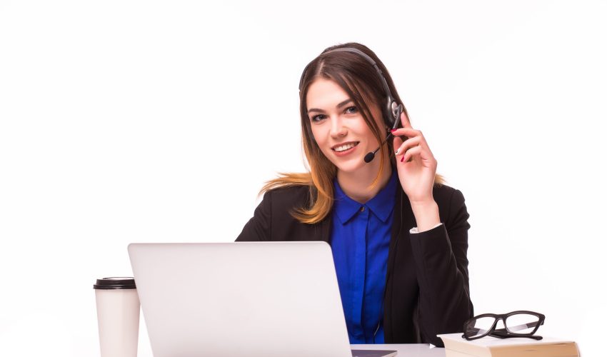 Portrait of smiling cheerful beautiful young support phone operator in headset with laptop, isolated over white background